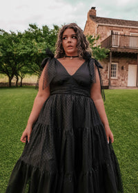 Black Jeanne Dress by JessaKae, showing a fitted dress with a scoop neckline and short sleeves on a model.