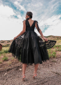 Black Jeanne dress by JessaKae, featuring a stylish silhouette, sleeveless design, and knee-length cut, modeled on a mannequin.