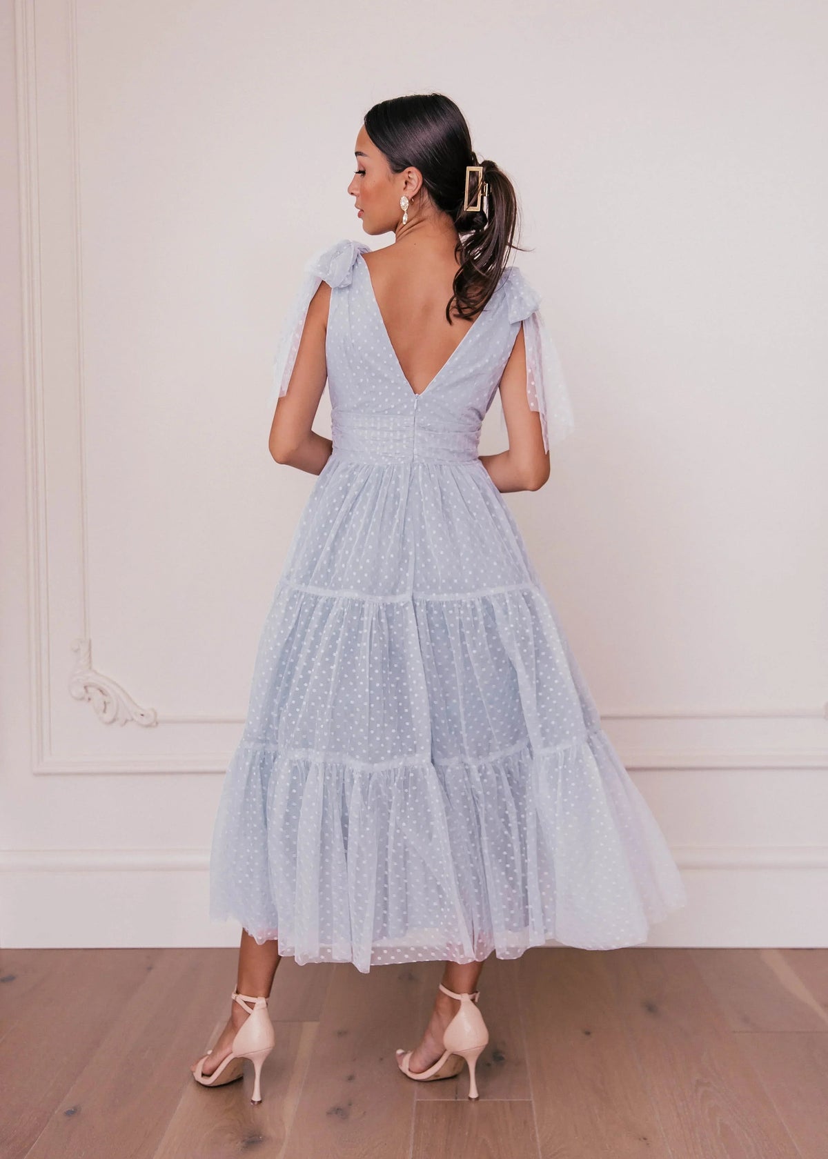 Dusty blue Jeanne Dress by JessaKae, flowing fabric, V-neckline, and long sleeves, stylish and elegant for any occasion.