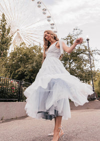 Dusty blue Jeanne dress by JessaKae featuring a flowy silhouette, V-neckline, and elegant design, perfect for casual or formal occasions.