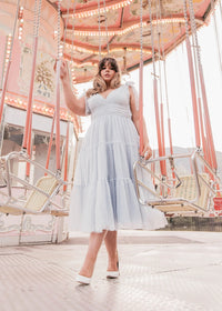 Dusty blue Jeanne dress by JessaKae featuring a flowy silhouette and elegant design, displayed on a model.