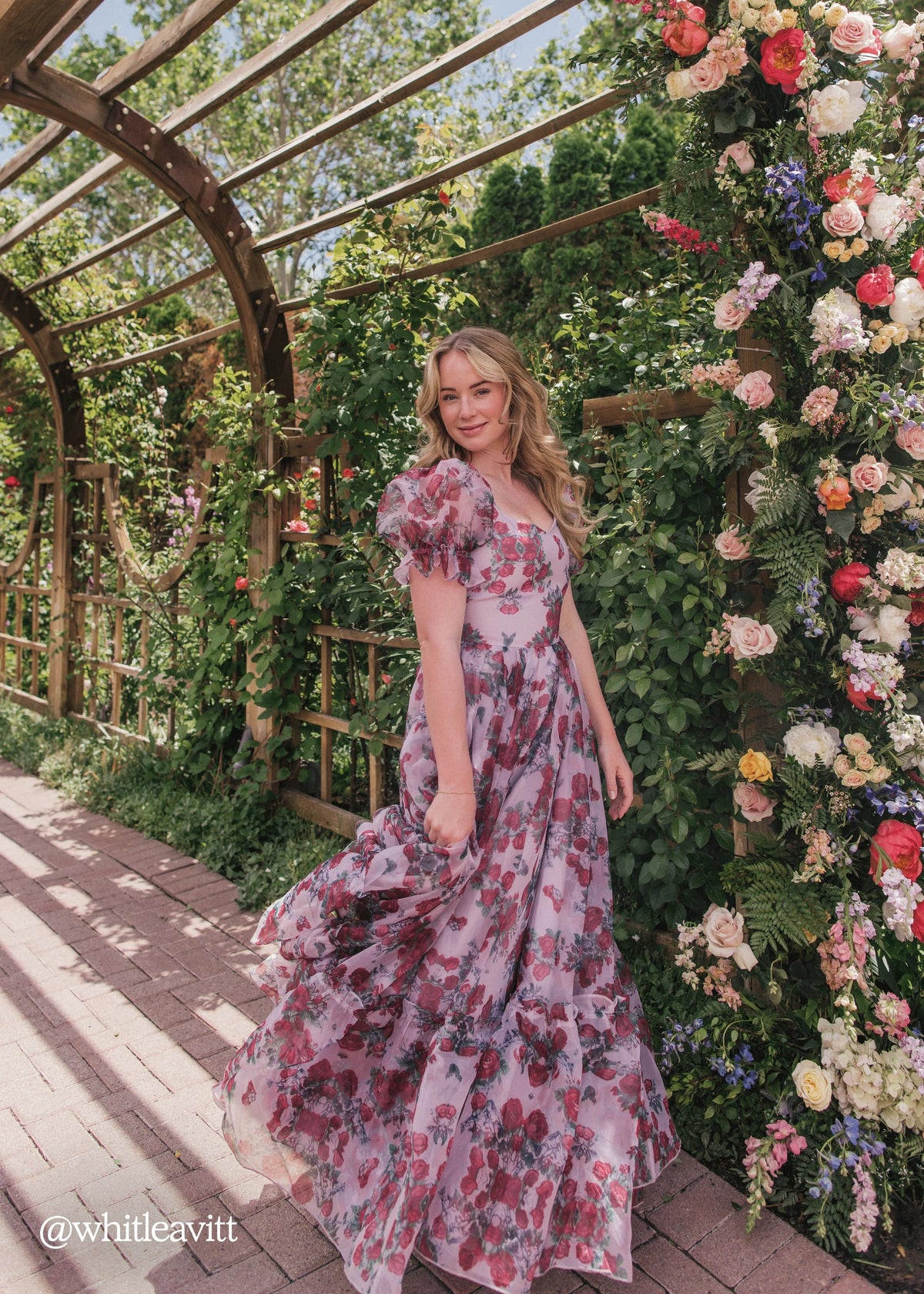 Lavender Cordelia Dress by JessaKae featuring a flowing design and floral rose pattern, displayed on a dress form.