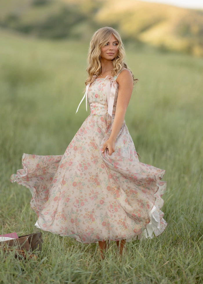 JessaKae Francesca Dress displayed on a hanger, featuring a flowy fabric and elegant design suitable for casual or formal occasions.