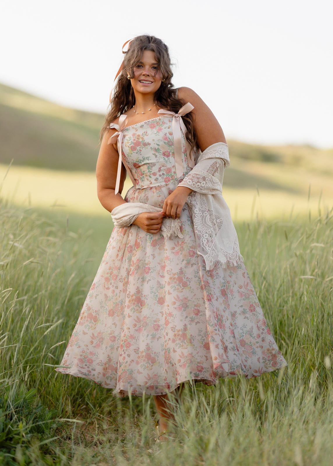 JessaKae Francesca Dress featuring a flowy silhouette, floral pattern, and sleeveless design displayed on a hanger.