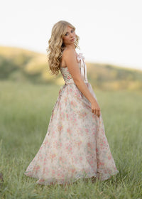 JessaKae Francesca dress in floral fabric with a flowing silhouette and short sleeves, displayed on a hanger.