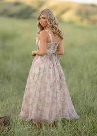 JessaKae Francesca Dress displayed on a hanger, featuring a flowy fabric and elegant design in a soft color.