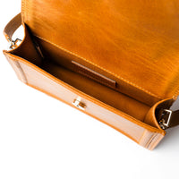 Camel leather mini crossbody handbag by Kila Siku featuring a sleek design and adjustable strap.