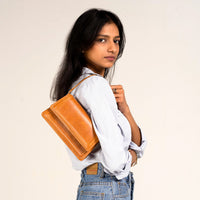 Camel leather mini crossbody bag with short handle from Kila Siku, featuring a sleek design and compact size.