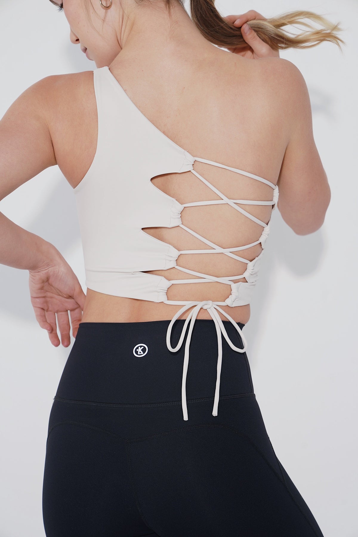 Ivory I Am Wise tie-up bra by KIMITH BRAND featuring adjustable straps and lace details, displayed on a mannequin.