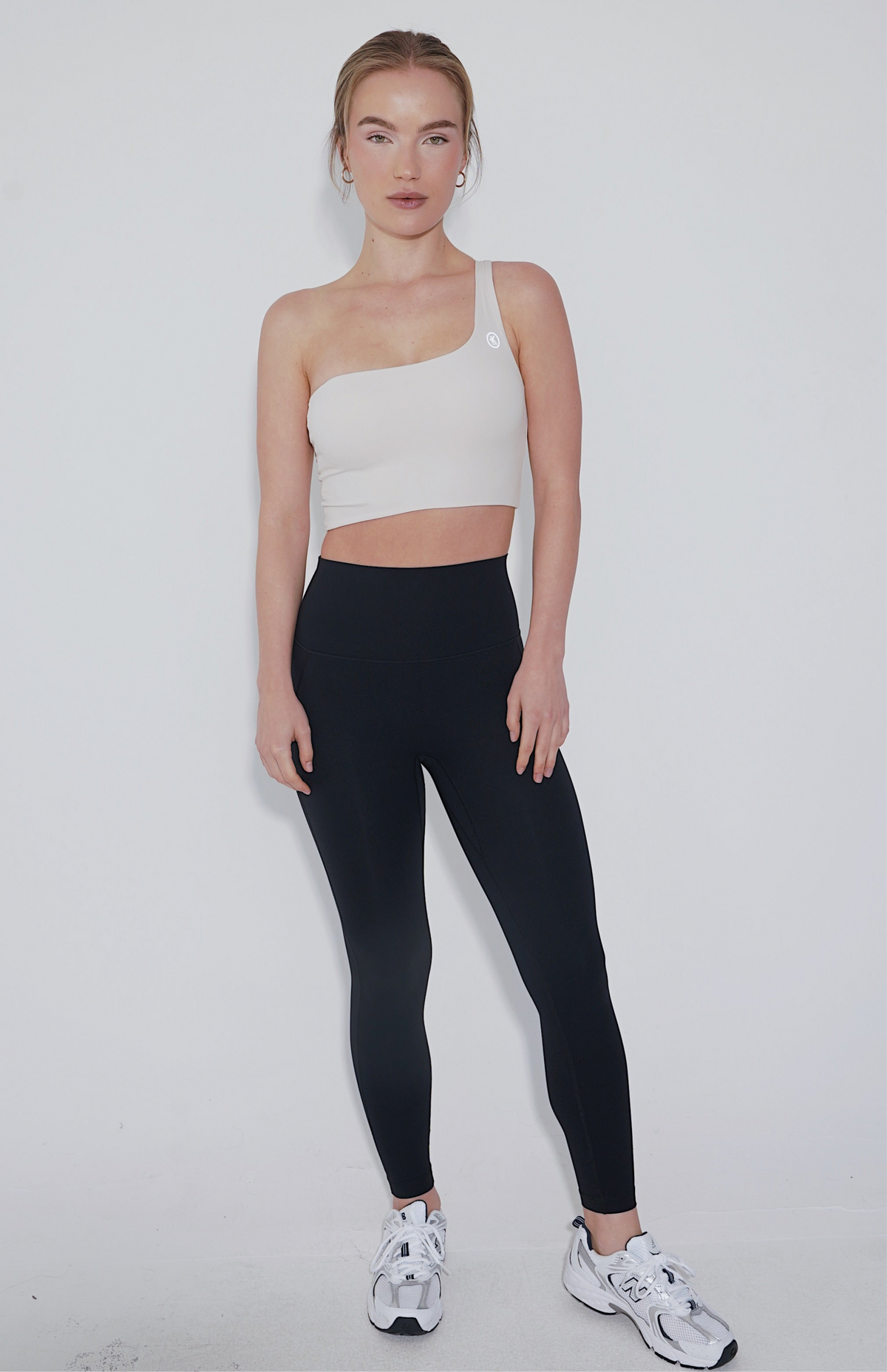 Ivory I Am Wise tie-up bra by KIMITH BRAND with adjustable straps and lace details, displayed on a flat surface.