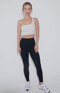 Ivory I Am Wise tie-up bra by KIMITH BRAND with adjustable straps and lace details, displayed on a flat surface.