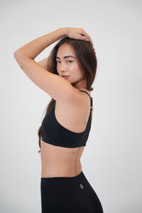 Black sports bra from KIMITH BRAND with comfortable fit, designed for active wear and stylish athletic performance.