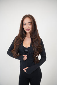 Black sports bra from KIMITH BRAND featuring a sleek design and comfortable fit, perfect for activewear and workout sessions.