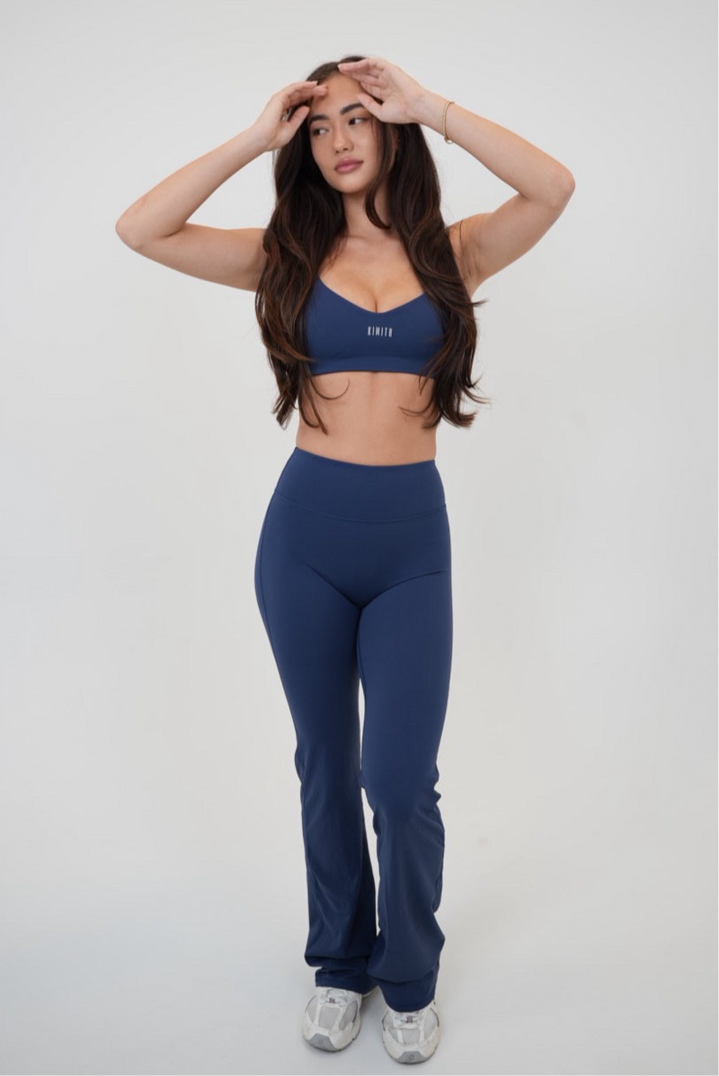Navy blue KIMITH BRAND sports bra with supportive design, suitable for active wear and fitness activities.