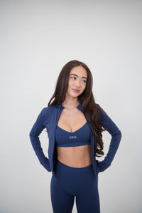 Navy blue KIMITH BRAND sports bra with supportive design, featuring breathable fabric and a sleek, comfortable fit.