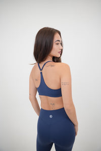Navy blue sports bra by KIMITH BRAND featuring a comfortable, supportive design ideal for active wear.
