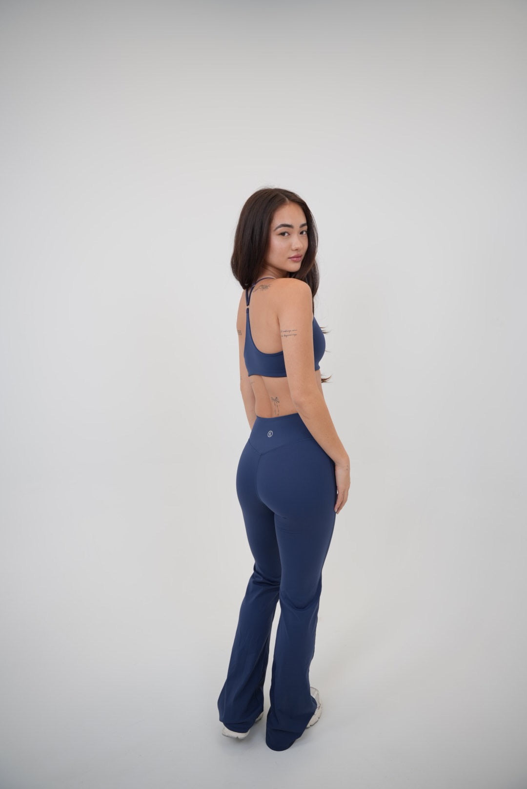 Navy blue KIMITH BRAND sports bra with supportive design, suitable for activewear and fitness activities.
