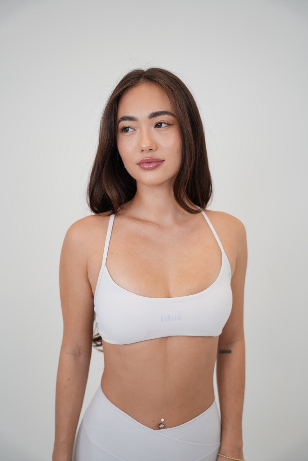 White cross-back butter-soft bra by KIMITH BRAND with lime accents and a comfortable, supportive design.