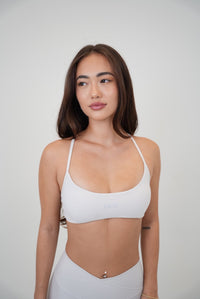 White cross-back butter-soft bra by KIMITH BRAND with lime accents and a comfortable, supportive design.