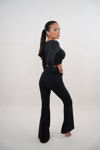 Black stretch flare legging by KIMITH BRAND featuring a fitted waistband and flared leg design for a stylish, comfortable look.