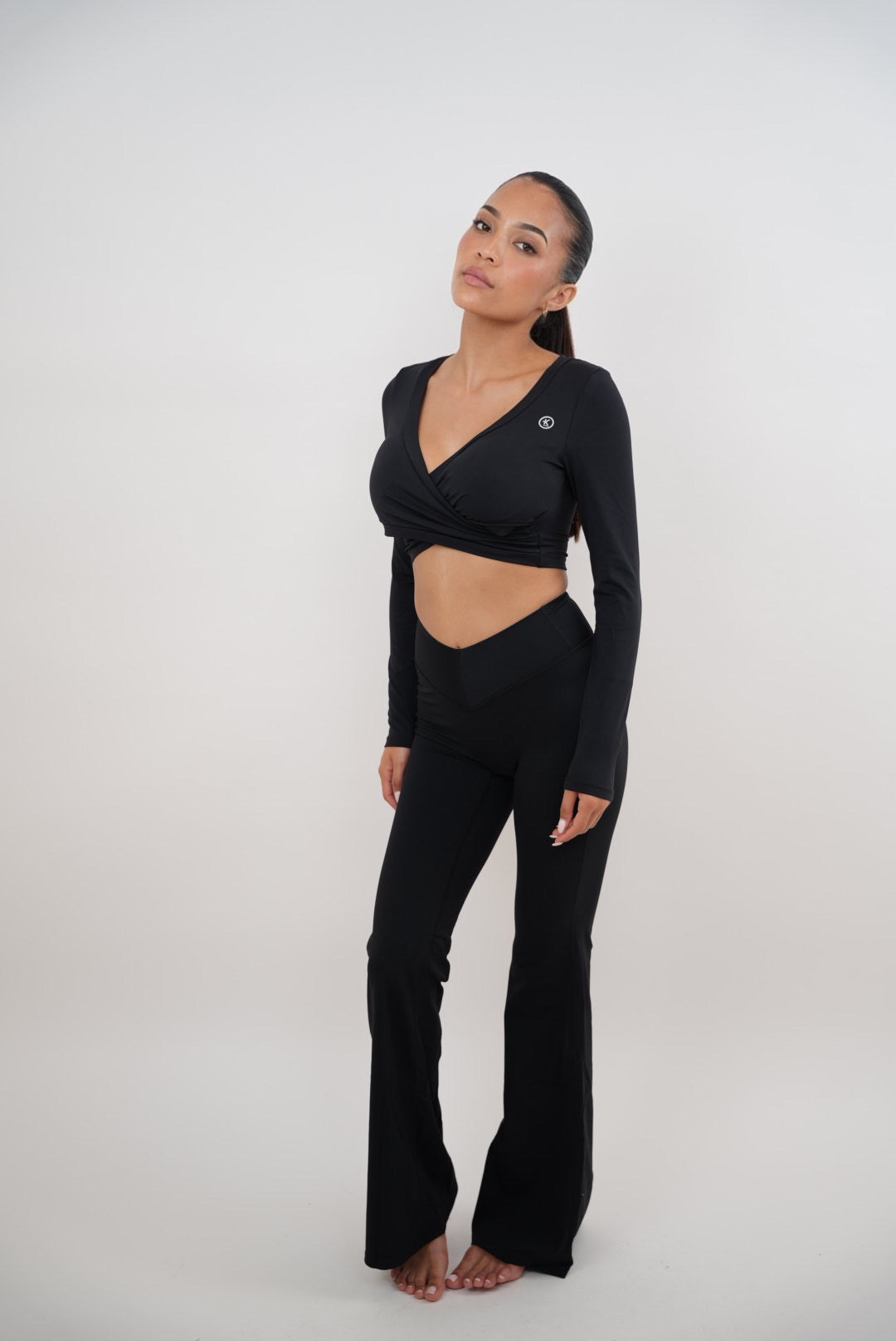 Black stretch flare leggings by KIMITH BRAND featuring a comfortable fit and stylish flare design.