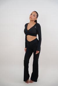 Black stretch flare leggings by KIMITH BRAND featuring a comfortable fit and stylish flare design.