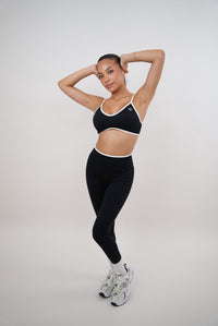 Black Kimith Brand Passion is Power legging featuring a snug fit, high waist, and bold printed slogan, shown on a model.