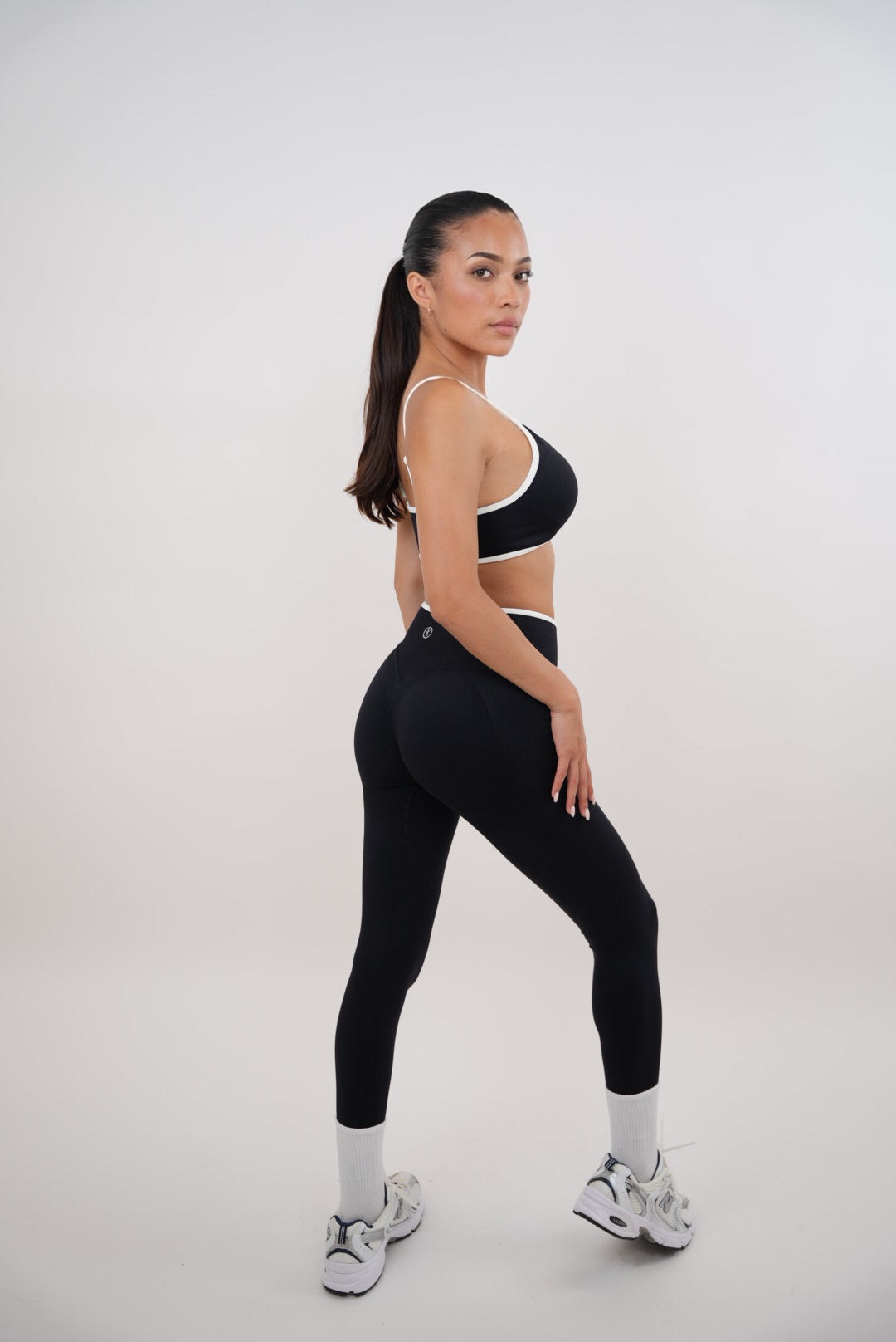 Black KIMITH BRAND passion is power leggings, close-up of stretchable fabric and sleek fit designed for active wear.