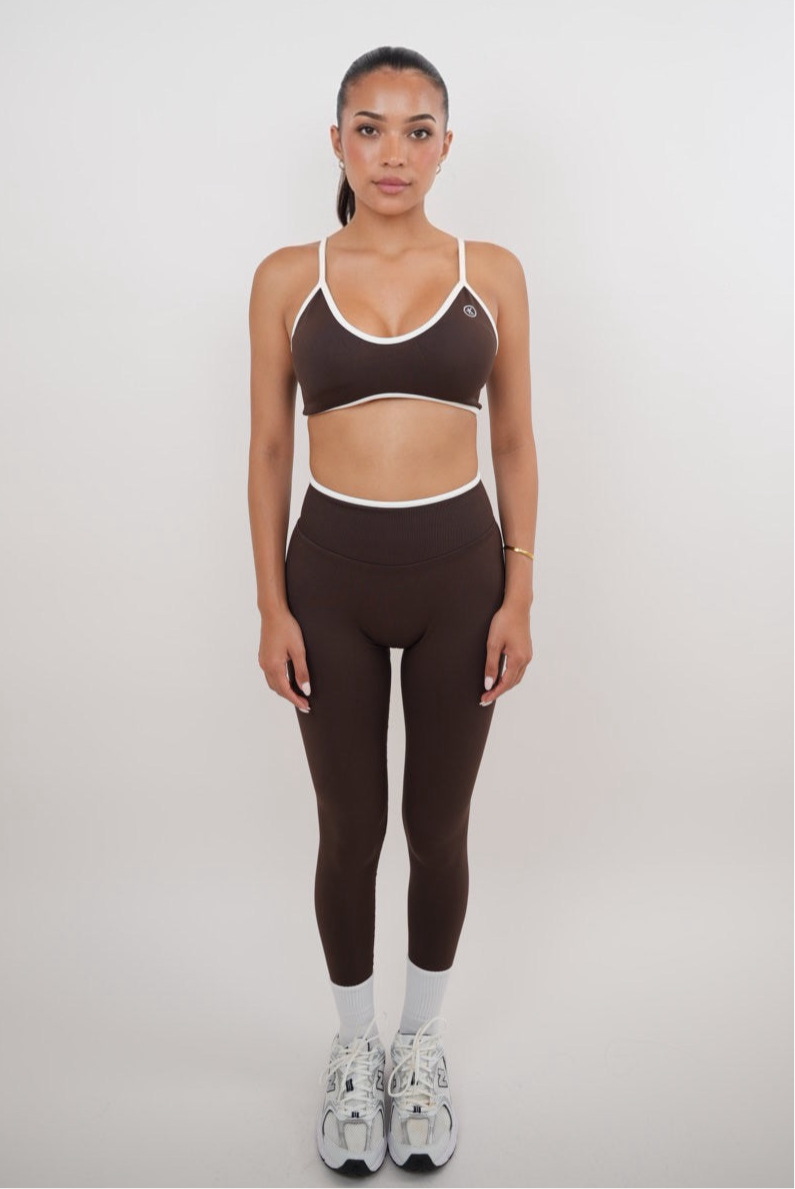 KIMITH BRAND Passion is Power brown leggings, XS size, close-up of stretchy fabric and waistband design.