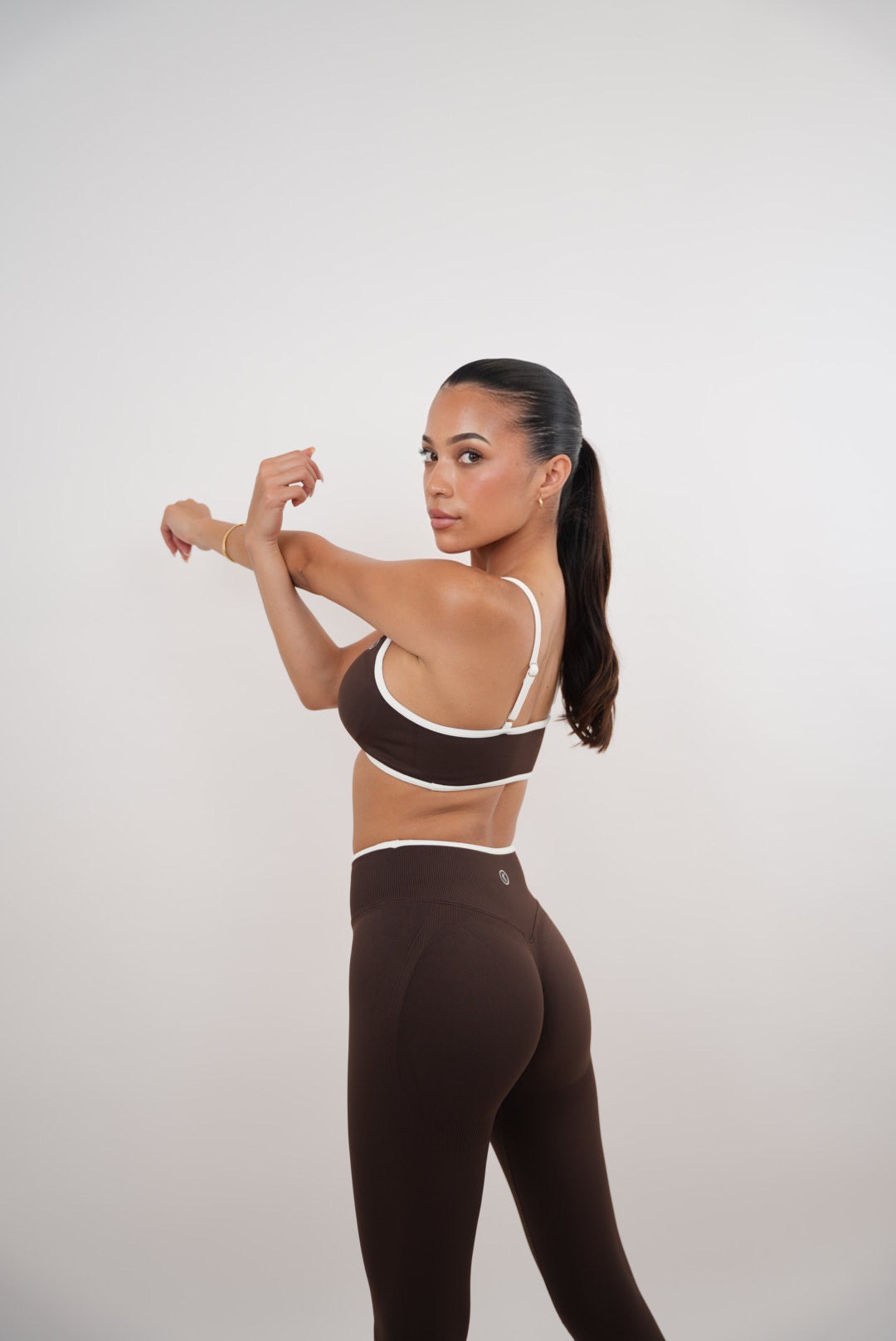 Kimith Brand brown Passion is Power leggings, made of stretchy fabric, shown on a model, highlighting the fit and design.