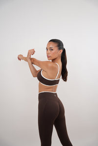 Kimith Brand brown Passion is Power leggings, made of stretchy fabric, shown on a model, highlighting the fit and design.