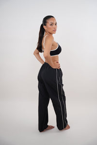 Black relaxed fit pant by KIMITH BRAND, versatile and comfortable with an "I Accept Change with Grace" design.