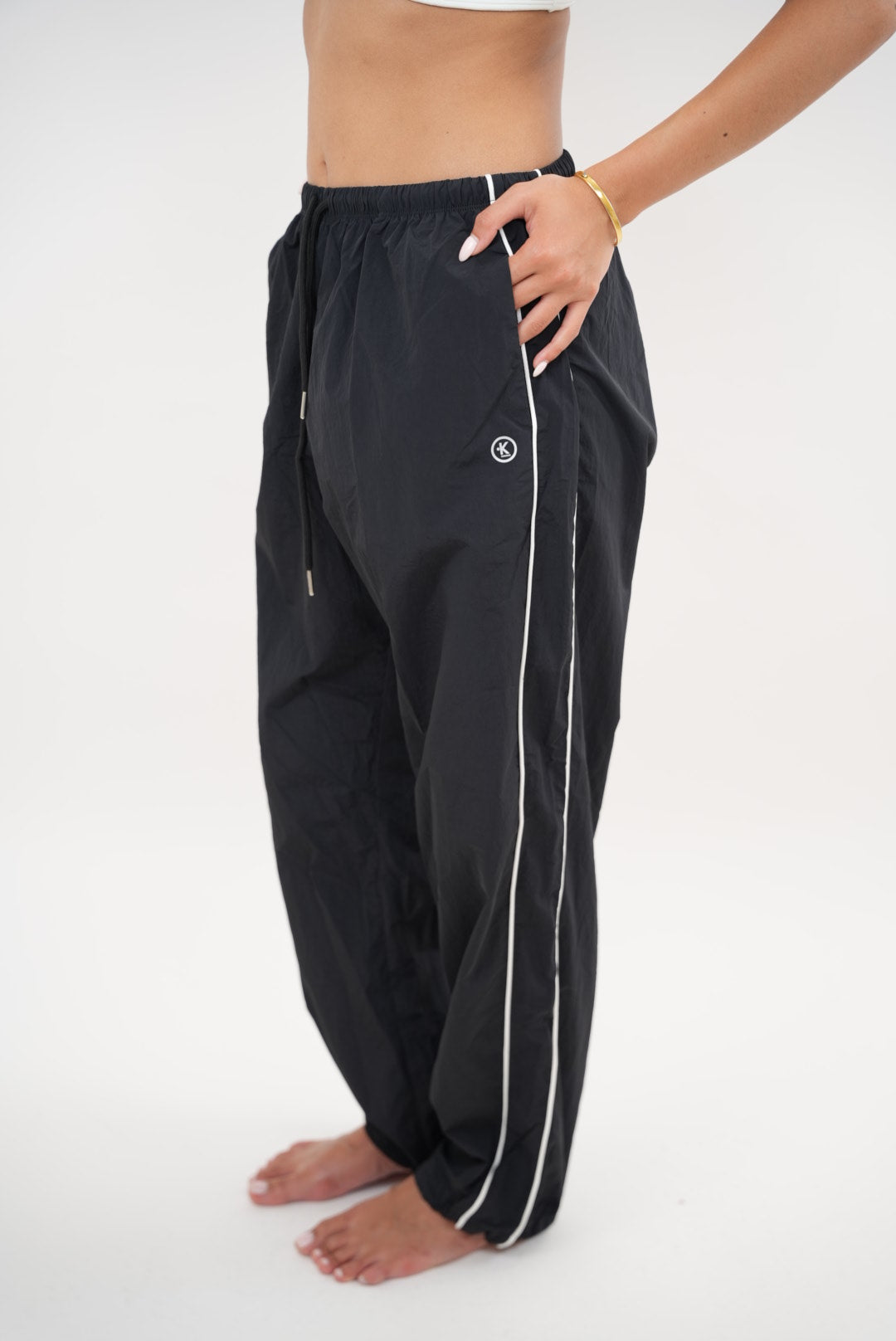 Black relaxed fit pant by KIMITH BRAND with "I Accept Change with Grace" text, versatile and comfortable for casual wear.