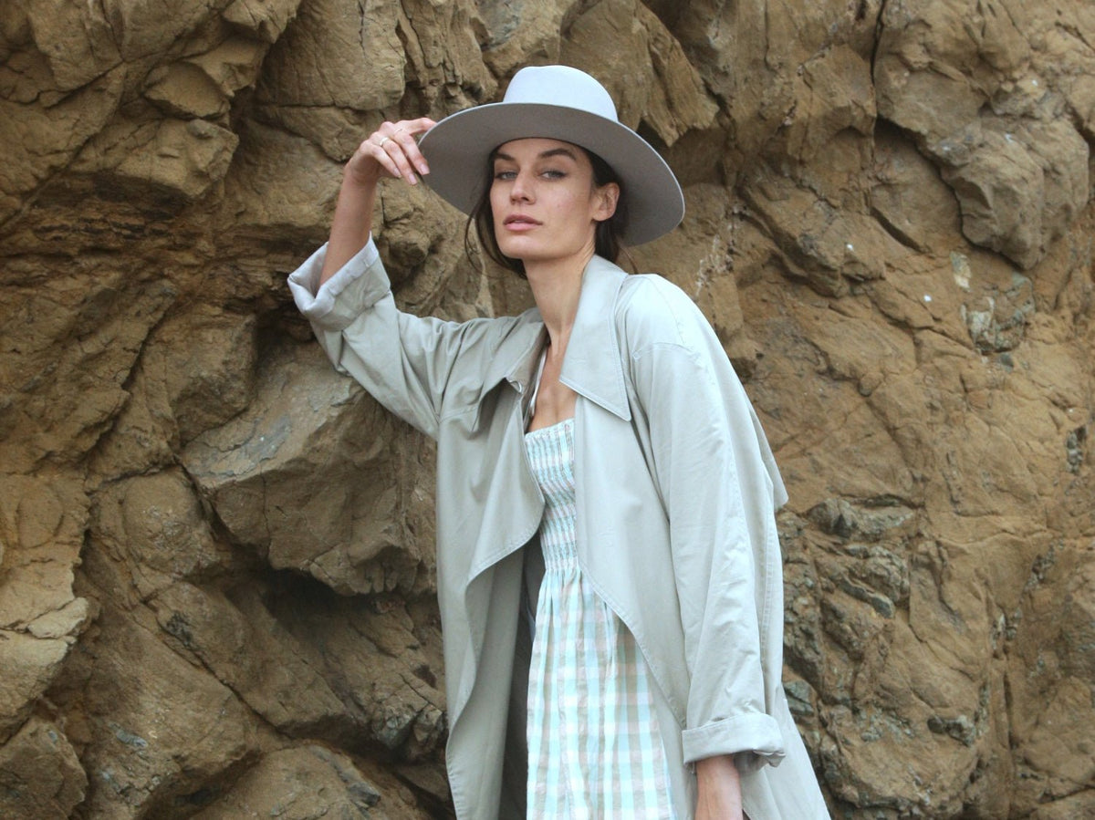 Urban Collection by KIN THE LABEL featuring a stylish model wearing contemporary streetwear in a city setting.