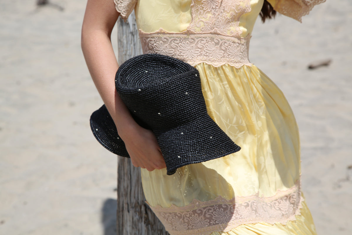 Kin the Label Resort Collection straw hat with a wide brim and raffia material, perfect for sunny beach days.