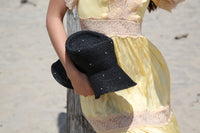 Kin the Label Resort Collection straw hat with a wide brim and raffia material, perfect for sunny beach days.