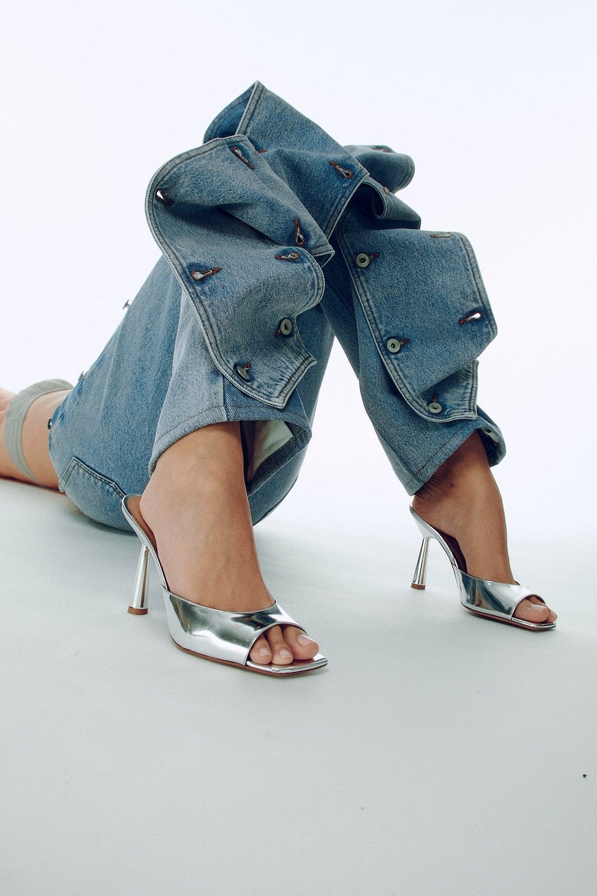 Silver Greta Mule by Kolane featuring mirror leather, low high heel, and classic mule silhouette.