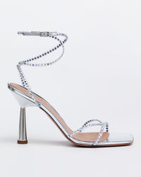 Silver Kolane High Kim Sandal with crystal embellishments, showcasing elegant straps and sparkling details on a stylish footwear design.