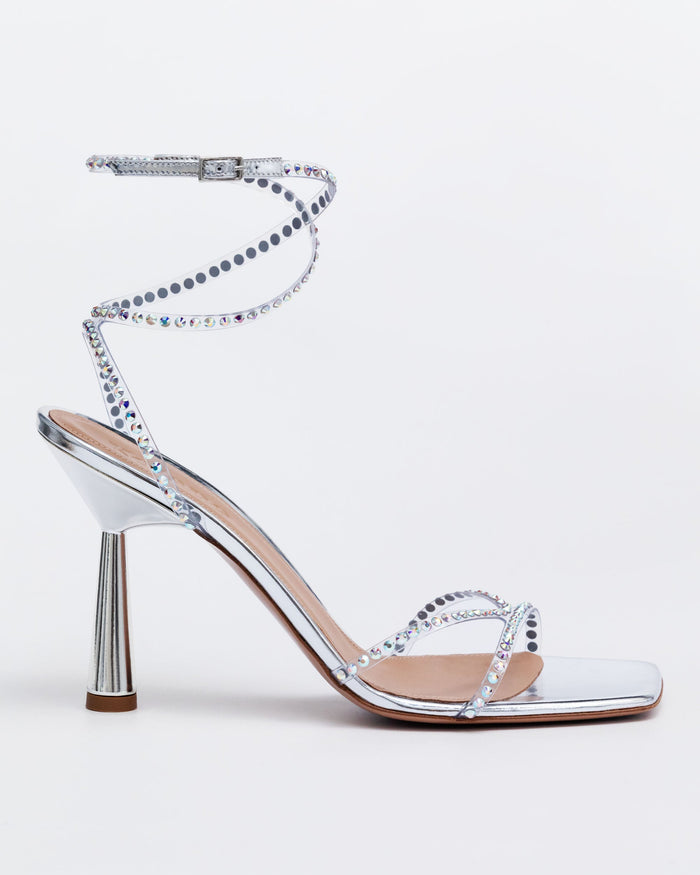 Silver Kolane High Kim Sandal with crystal embellishments, showcasing elegant straps and sparkling details on a stylish footwear design.