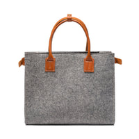 Kyrgies handmade wool handbag with colorful woven design and wooden handles, showcasing artisanal craftsmanship and vibrant style.