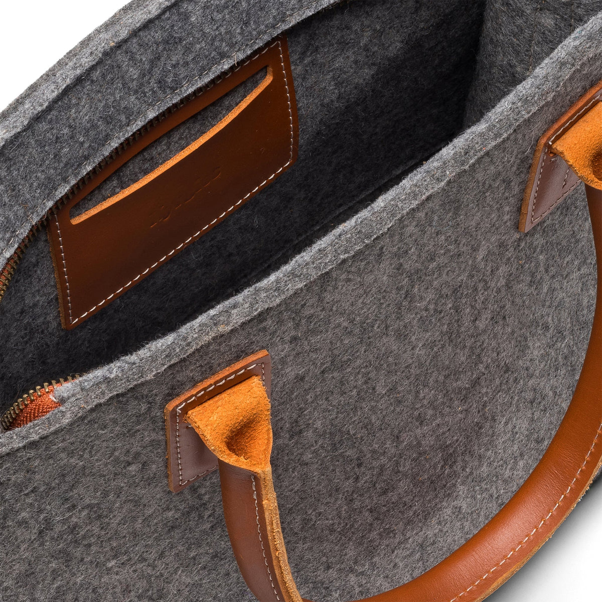 Kyrgies handmade wool handbag featuring a colorful, textured design with a leather strap and natural fiber details.