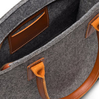 Kyrgies handmade wool handbag featuring a colorful, textured design with a leather strap and natural fiber details.