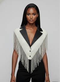 L'Jai Amor CEO Energy Cape in vibrant fabric, draped on a mannequin, showcasing its flowing design and bold color pattern.