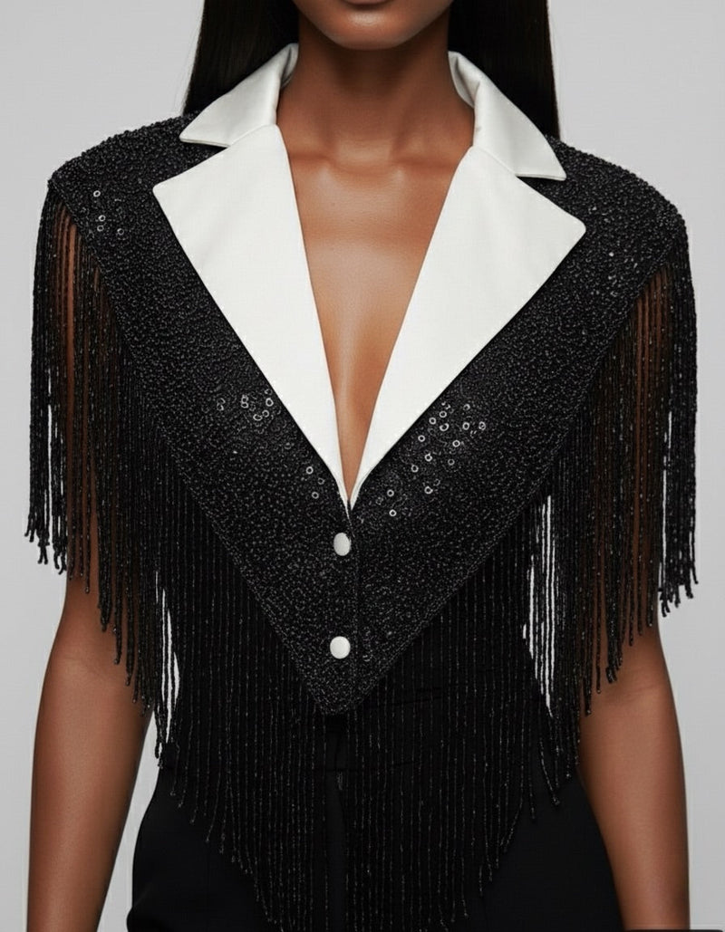L'Jai Amor The Strategist Cape displayed on a hanger, showcasing its stylish design and fabric details.