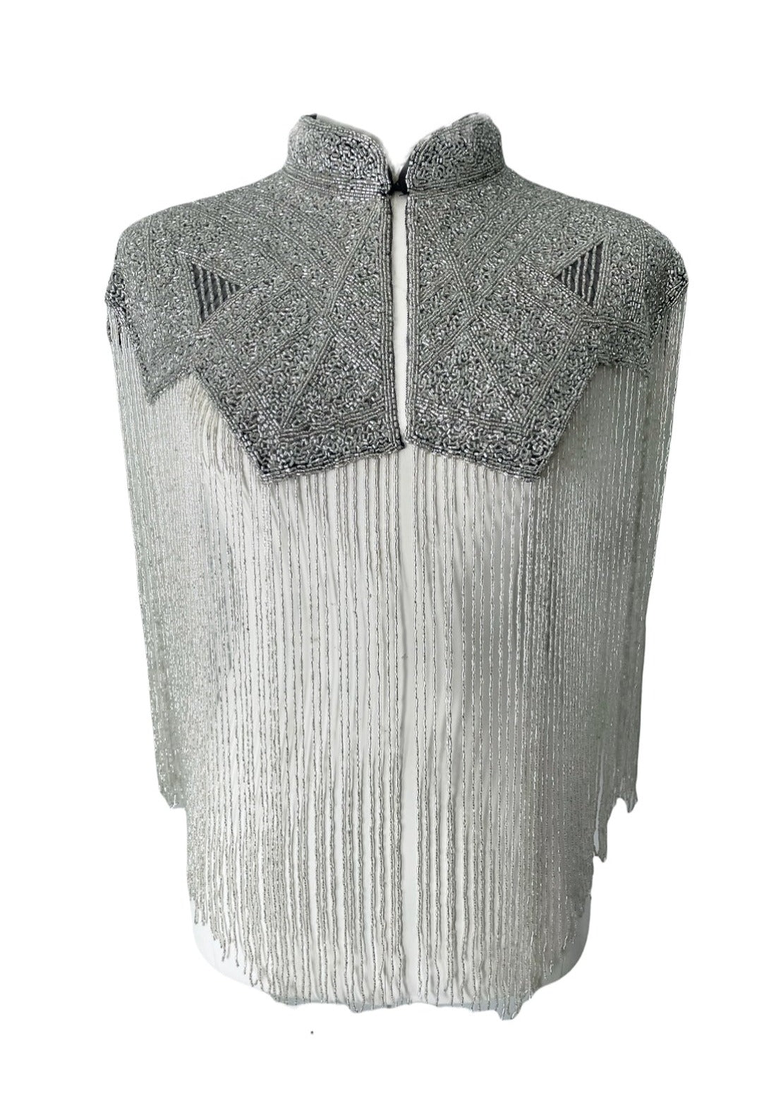 L'Jai Amor Argent Line Cape displayed on a hanger, showcasing its elegant silver fabric and flowing design.