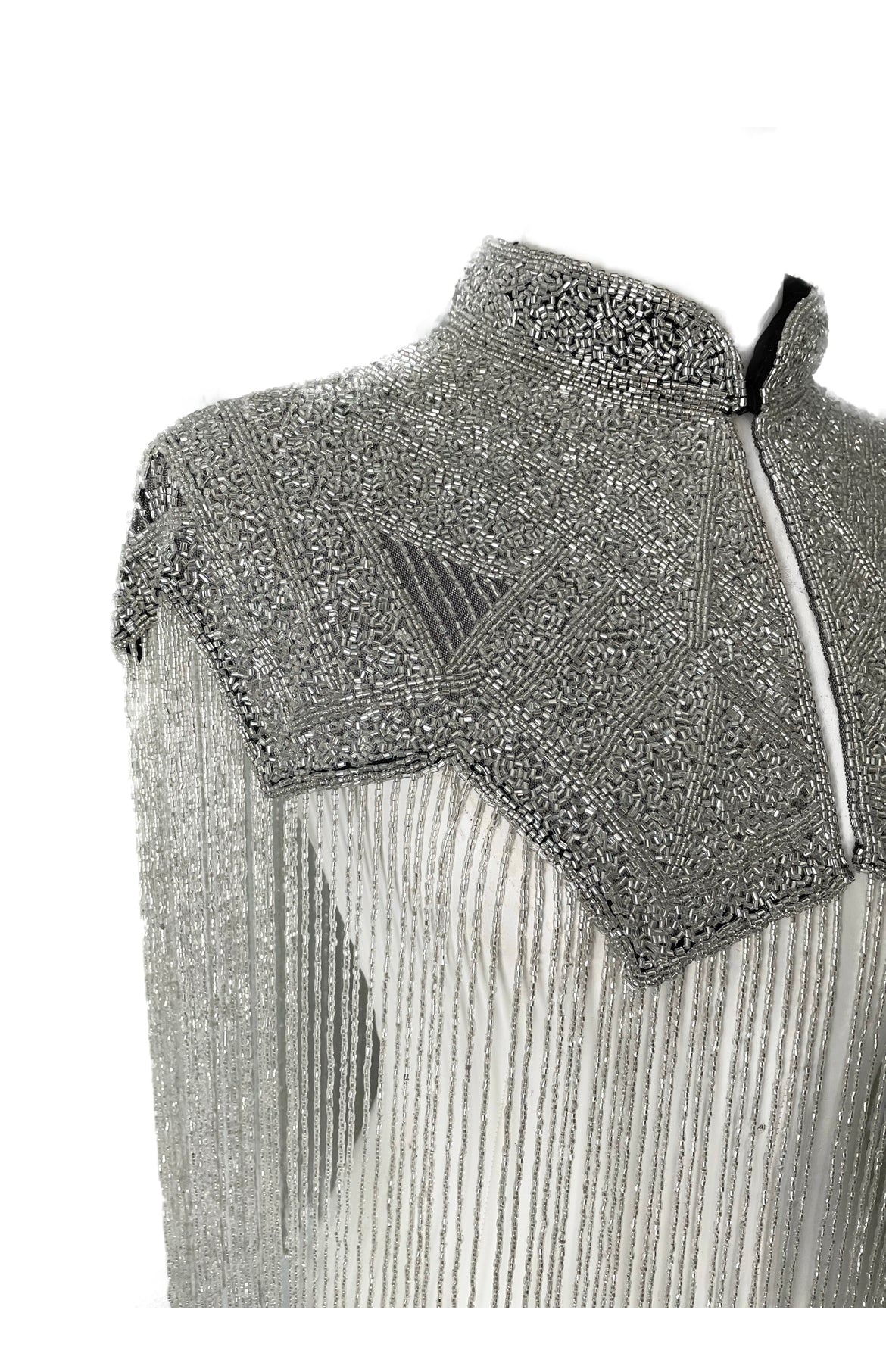 L'Jai Amor Argent Line cape draped over a mannequin, showcasing elegant design and lightweight fabric for stylish layering.
