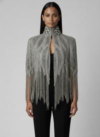 L'Jai Amor Argenté Cascade Cape draped over shoulders, showcasing shiny silver fabric with elegant flowing design.