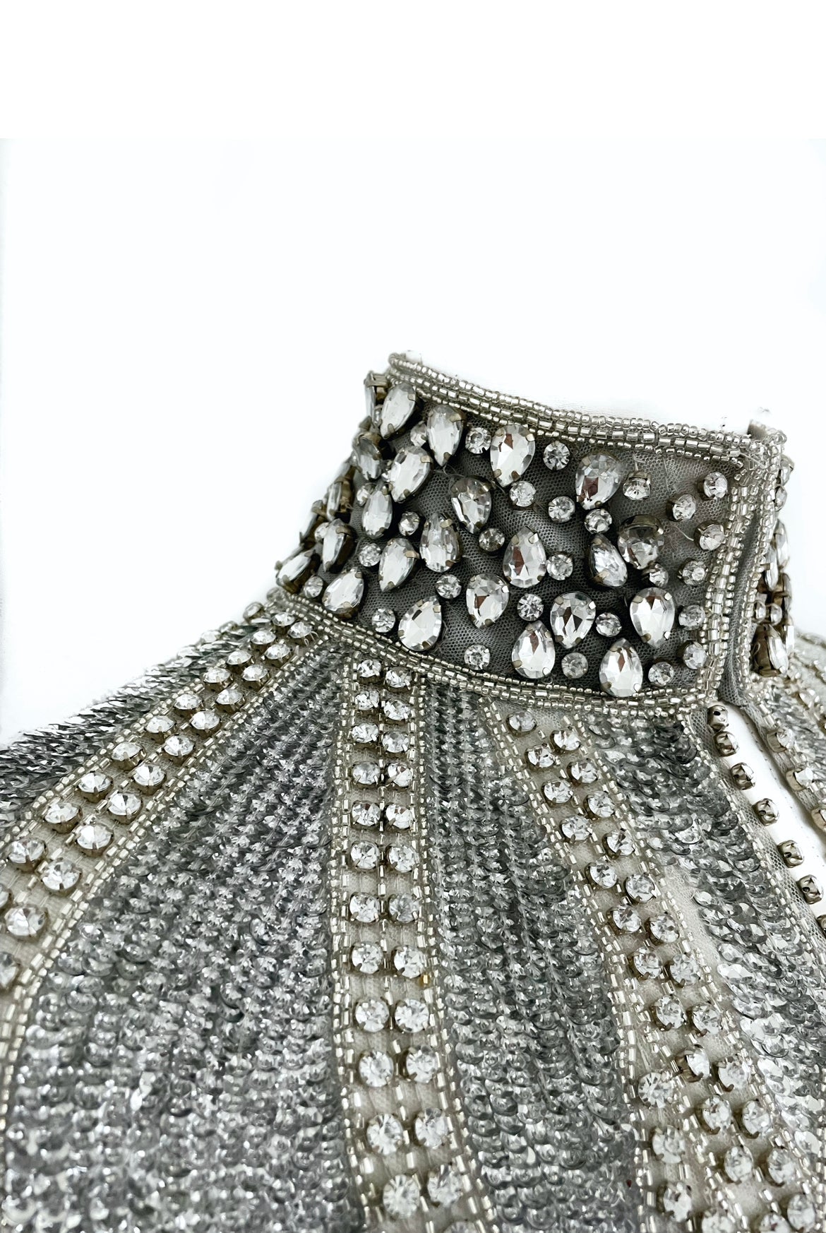 L'Jai Amor Argenté Cascade Cape draped over shoulders, featuring shimmering silver fabric with elegant flowing design.