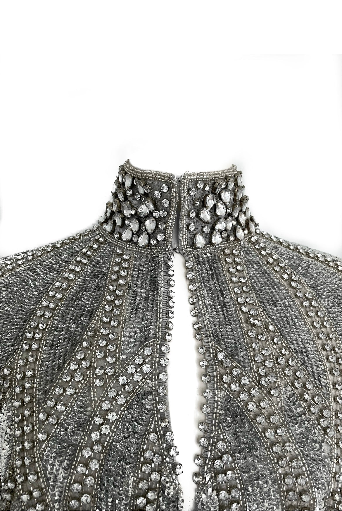 L'Jai Amor Argenté Cascade Cape draped over a mannequin, showcasing its elegant silver fabric and flowing design.