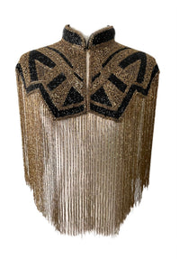 L'Jai Amor Axis Line Cape displayed on a hanger, featuring elegant fabric and stylish design for a layered fashion look.